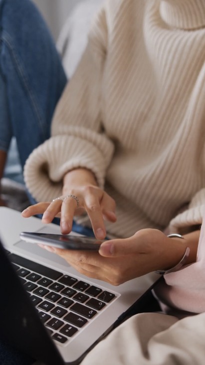 Close-up of hands typing on a laptop